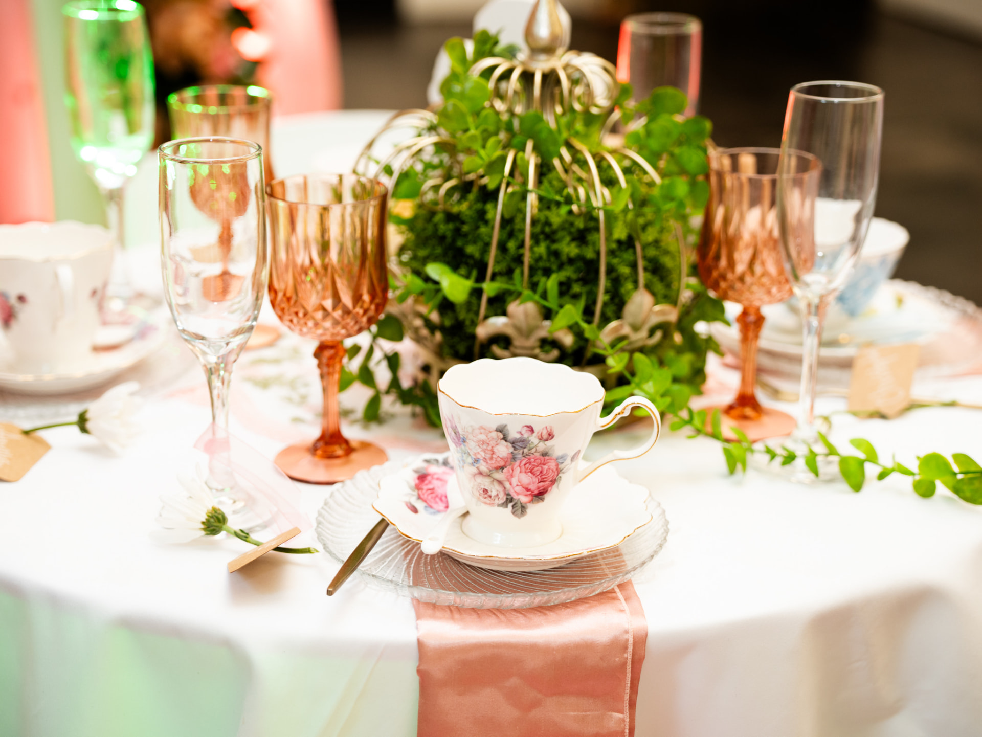 Vintage teacup and glassware on a styled table